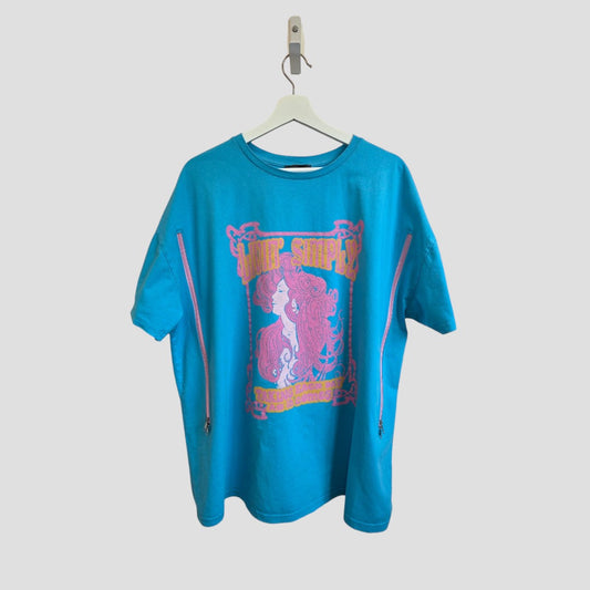The Primark Upcycled Breastfeeding & Pumping Turquoise/Pink Girl t-shirt (L, UK14/16, 100501) features a bold woman graphic with text and side zippers for easy nursing. Displayed on a white hanger against a plain background.