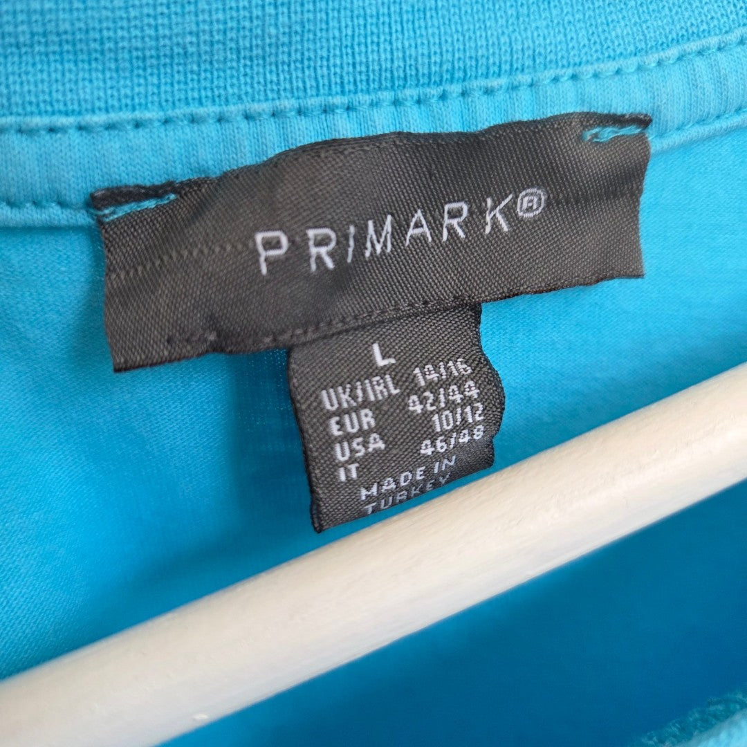 Close-up of a black Primark label on the Upcycled Breastfeeding & Pumping Turquoise/Pink Girl t-shirt (L, UK14/16), showing sizing for UK, EUR, USA, and IT. This affordable nursing option was made in Turkey.