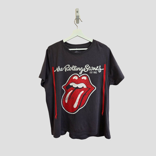 A Primark upcycled breastfeeding & pumping t-shirt in XL, featuring The Rolling Stones tongue logo in grey/red, hangs on a white hanger against a plain gray background.