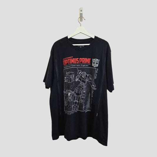 The George Upcycled Breastfeeding & Pumping Transformers T-shirt (2XL, 100526) features a white schematic of Optimus Prime with bold red and white "Autobot Optimus Prime" text—an eco-friendly option for fans.