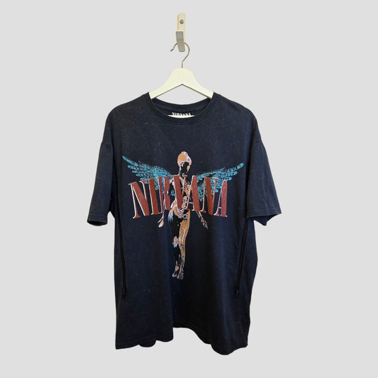A turquoise Nirvana Angel band T-shirt by Primark, size M (UK12/14), is upcycled for breastfeeding and pumping. Featuring the iconic winged angel design, this affordable maternity piece brings a rock-inspired edge to nursing wear.