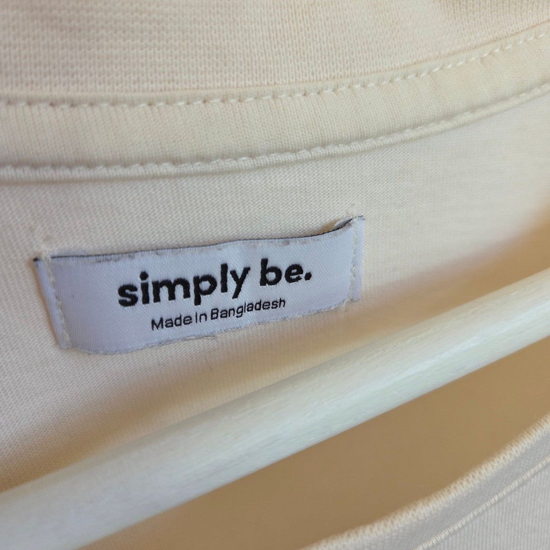 A close-up of a white Simply Be label on a cream Limon Lemon UK18 upcycled breastfeeding & pumping t-shirt, featuring bold black text and "Made in Bangladesh," sewn near the collar—ideal for affordable, eco-friendly nursing wear.