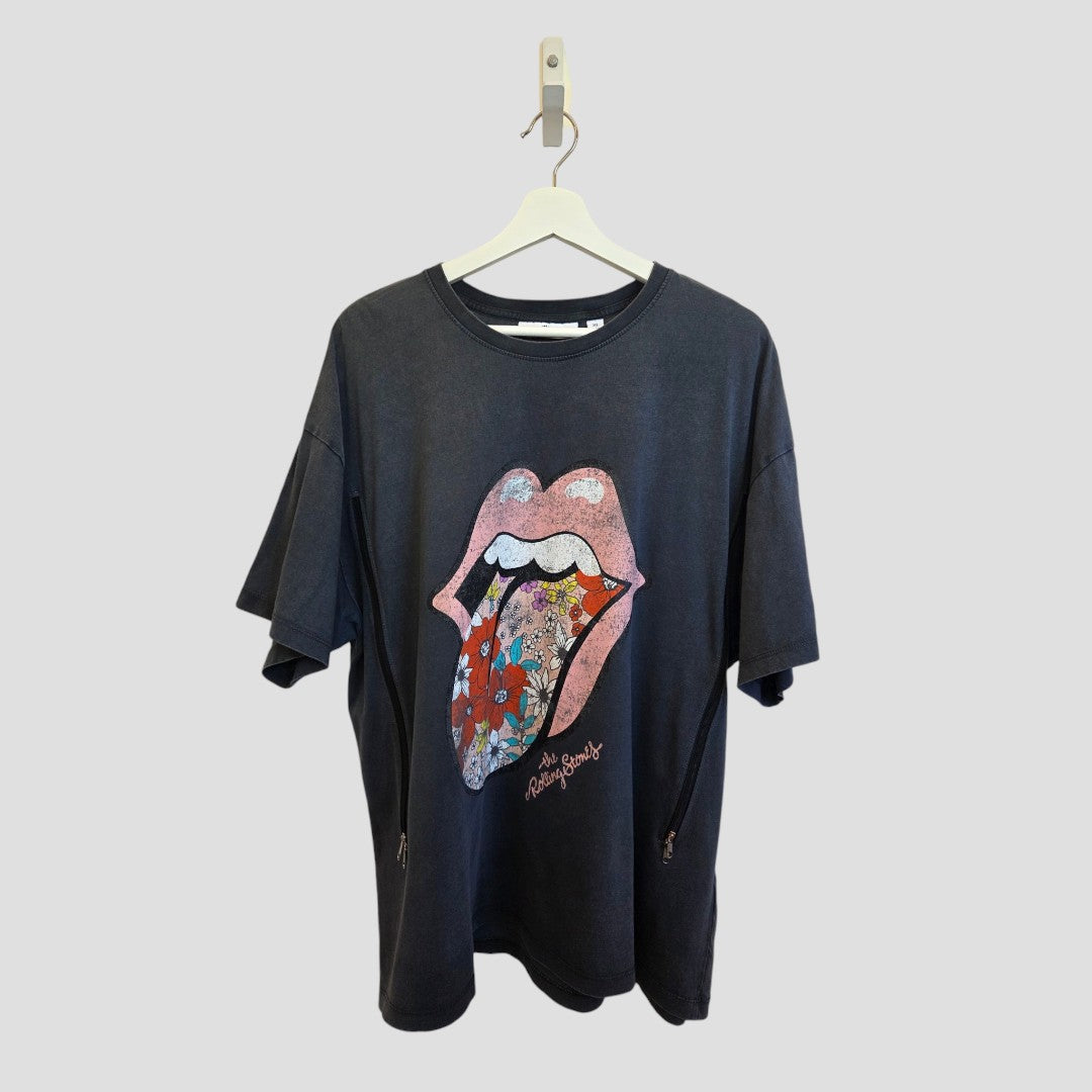 The Next Upcycled Breastfeeding & Pumping Floral The Rolling Stones Band t-shirt XL (100542) features a colorful lips and tongue graphic with a floral mouth, shown hanging on a white hanger against a plain gray background.