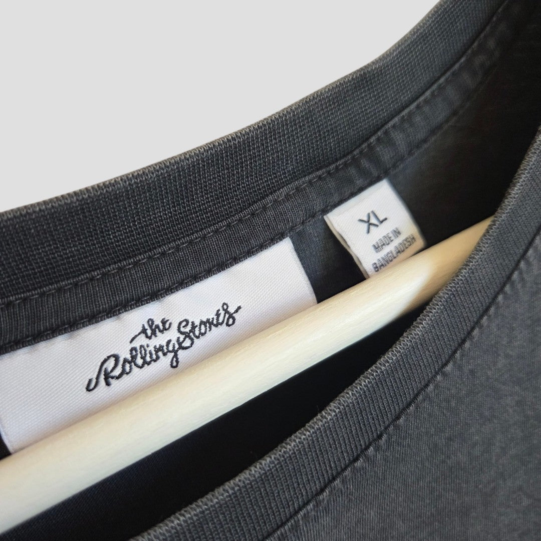 Close-up of an XL Upcycled Breastfeeding & Pumping Floral The Rolling Stones Band T-shirt by Next on a hanger, showing tags with brand and size—a stylish, eco-friendly choice for nursing clothing fans.