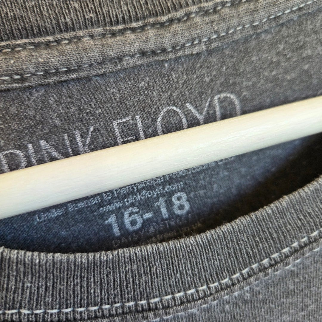 Close-up of a grey Upcycled Breastfeeding & Pumping Vintage Feel Pink Floyd Band t-shirt (UK16/18) on a hanger, showing the inside label with "Pink Floyd" and size 16-18—ideal for eco-conscious nursing wear.