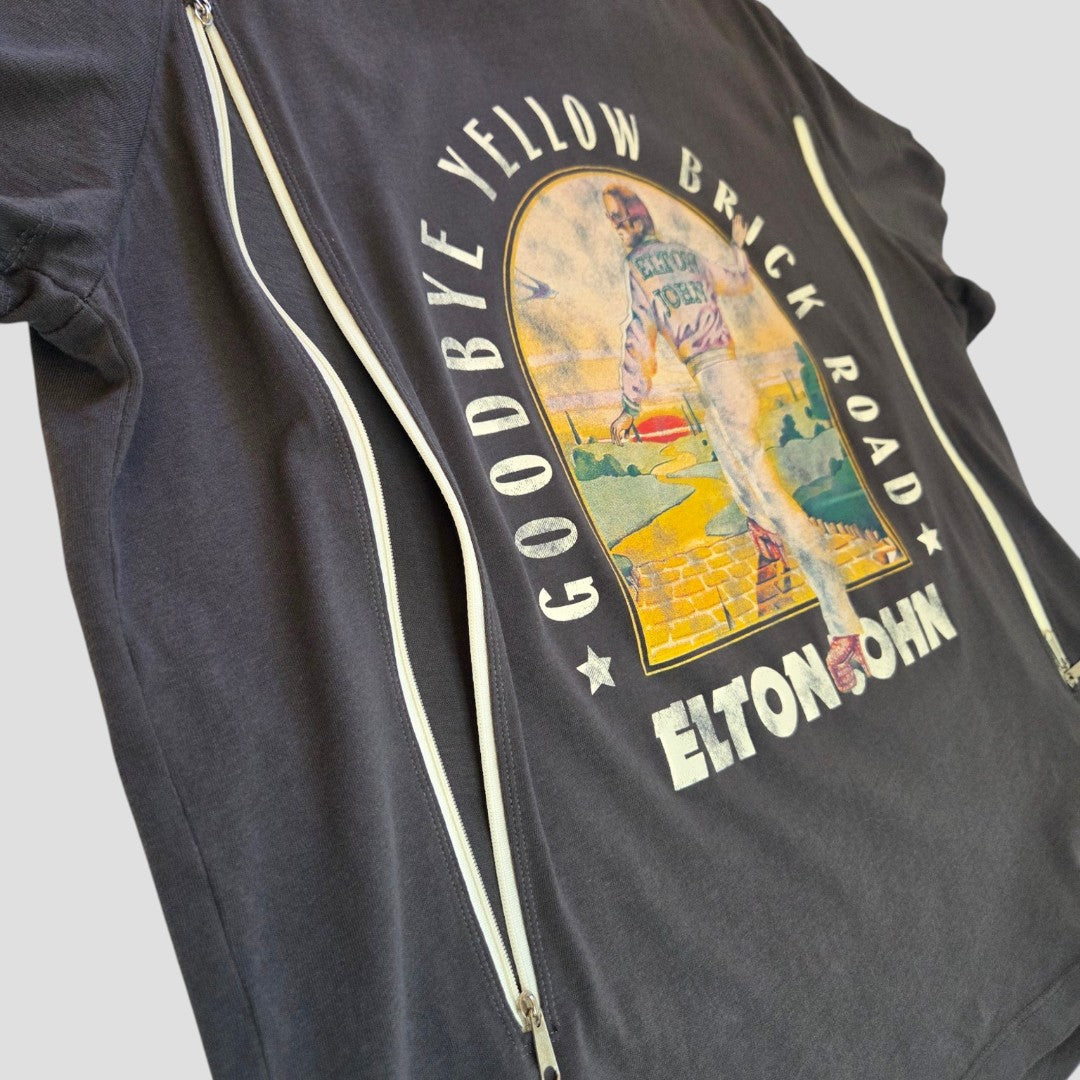 An upcycled dark gray XL H&M t-shirt for breastfeeding and pumping, featuring an Elton John "Goodbye Yellow Brick Road" band design with a person walking the yellow brick road.
