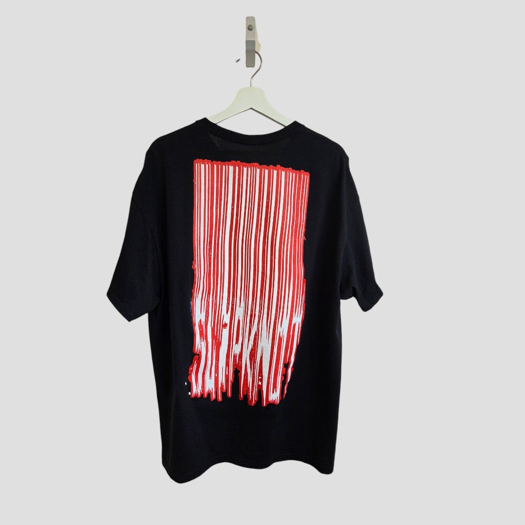 An upcycled Slipknot breastfeeding & pumping T-shirt (XL) in black/red hangs against a light gray background, featuring bold graphics on the back. Made from eco-friendly materials.