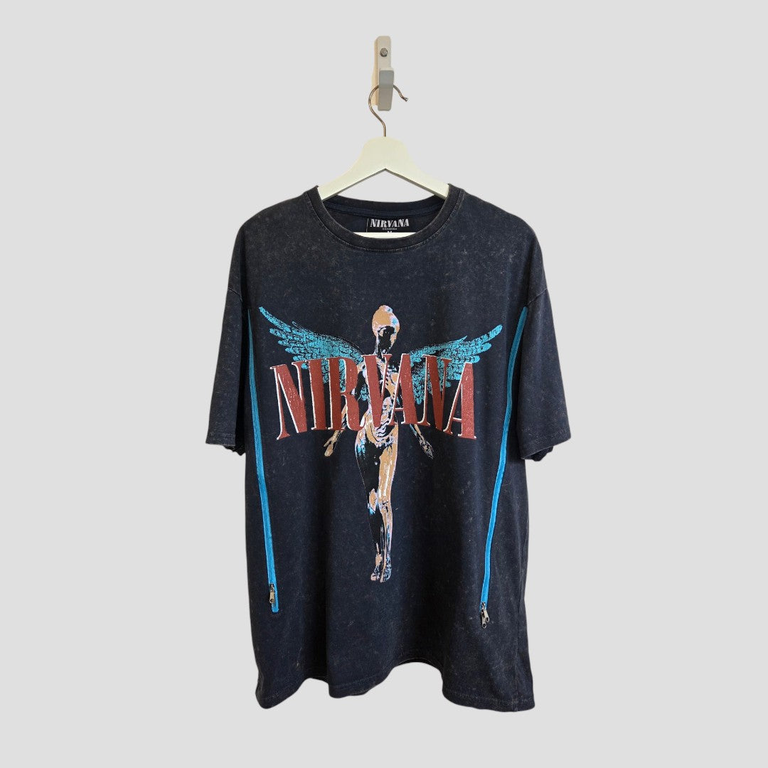 An upcycled grey/turquoise Nirvana Angel band t-shirt by Primark (size M, UK12/14), designed for breastfeeding and pumping, hangs on a white hanger against a light gray background.