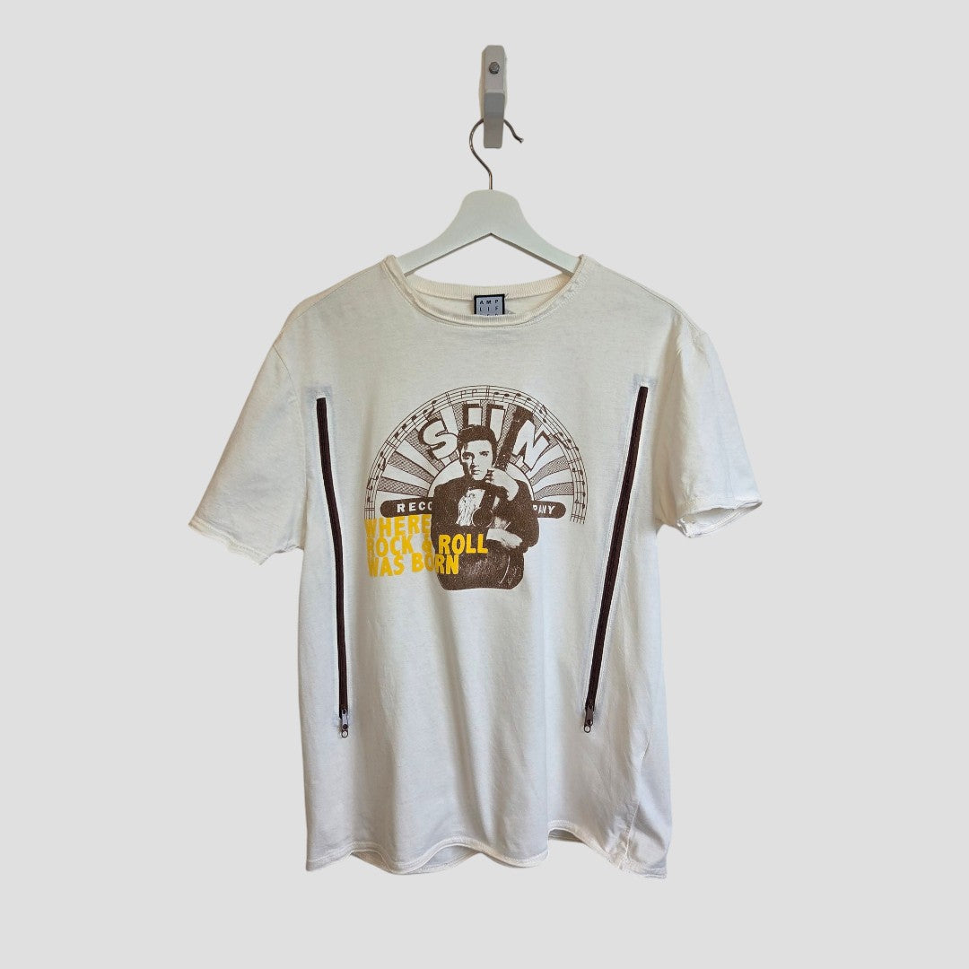 The Amplified Upcycled Breastfeeding & Pumping Cream Elvis Presley Band t-shirt (L, 100549) is an eco-friendly white tee featuring a graphic of Elvis Presley, "The Rock & Roll Legend" text, and two black side zippers.
