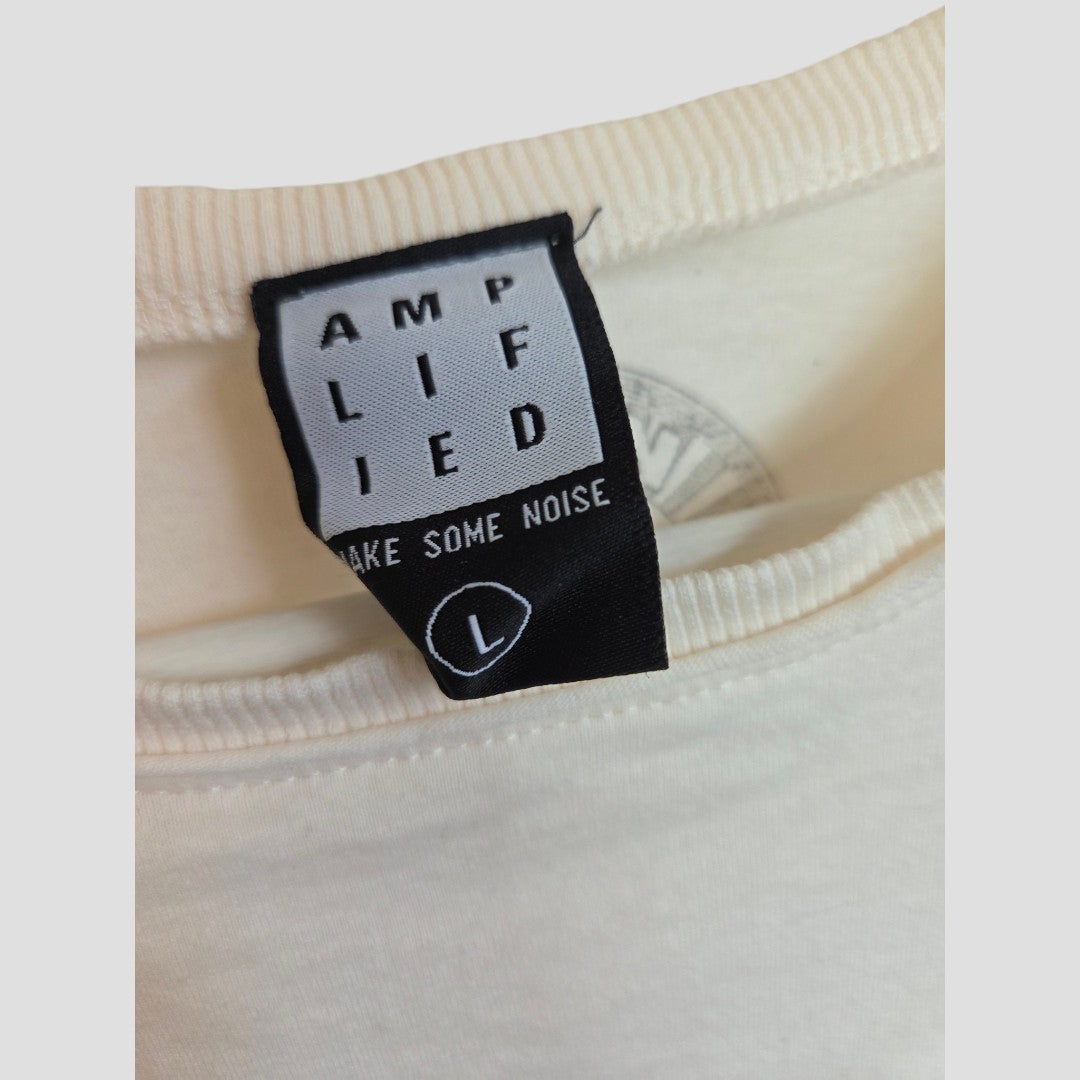 A close-up of a black and white clothing label on a cream-colored Upcycled Breastfeeding & Pumping Cream Elvis Presley Band t-shirt (L) by Amplified highlights the eco-friendly brand and size large, ideal for conscious shoppers.