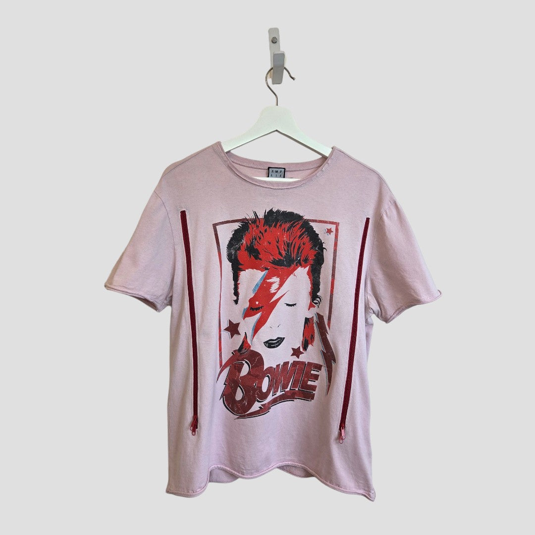 The Amplified Upcycled Breastfeeding & Pumping Pink David Bowie Band T-shirt (L) features Bowie's iconic face and lightning bolt, inspired by Aladdin Sane—an affordable, stylish nursing top for new moms.