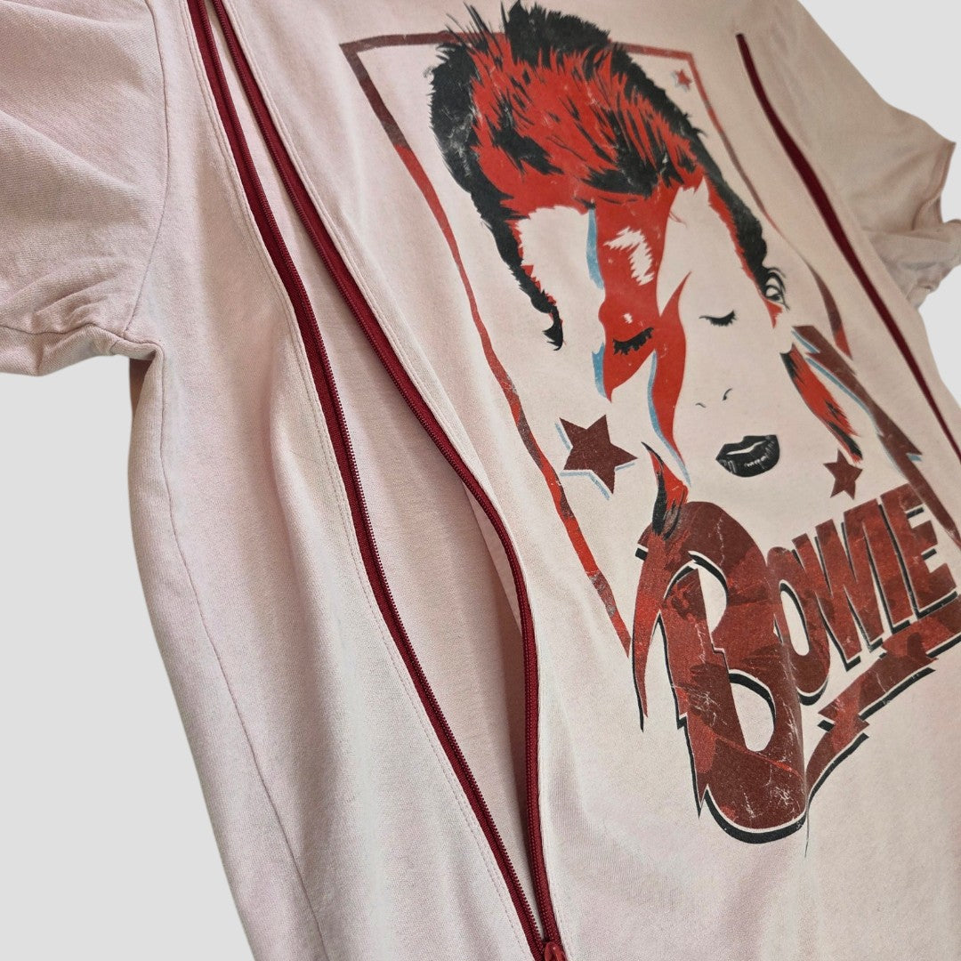 The Amplified Upcycled Breastfeeding & Pumping Pink David Bowie Band T-shirt (L) features bold "Bowie" lettering, a stylized lightning bolt, and two red zippers for easy nursing—an affordable, stylish choice for breastfeeding moms.