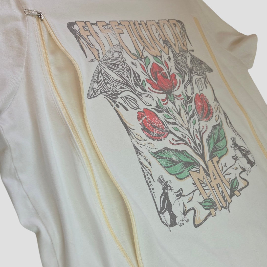 The Tu Upcycled Breastfeeding & Pumping Cream Floral Fleetwood Band T-shirt UK16 (100561) features tulips, butterflies, and animal figures with stylized Fleetwood Mac lettering—a stylish, functional breastfeeding top.