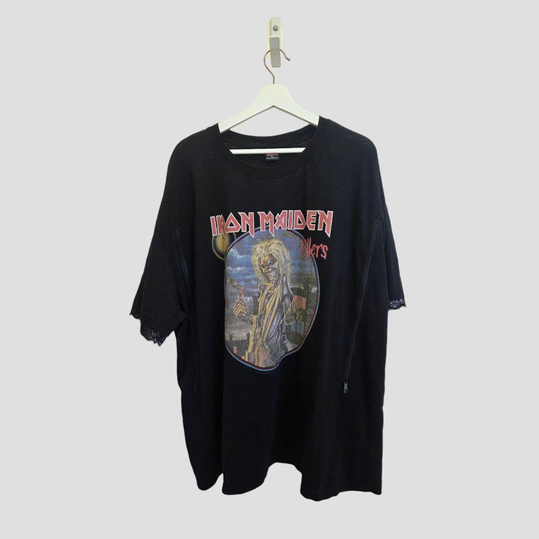 A black Primark Upcycled Breastfeeding & Pumping Iron Maiden Lace Band T-shirt (XL) hangs on a white hanger against a light gray background. Crafted from eco-friendly materials, the shirt showcases band artwork and lettering on the front.