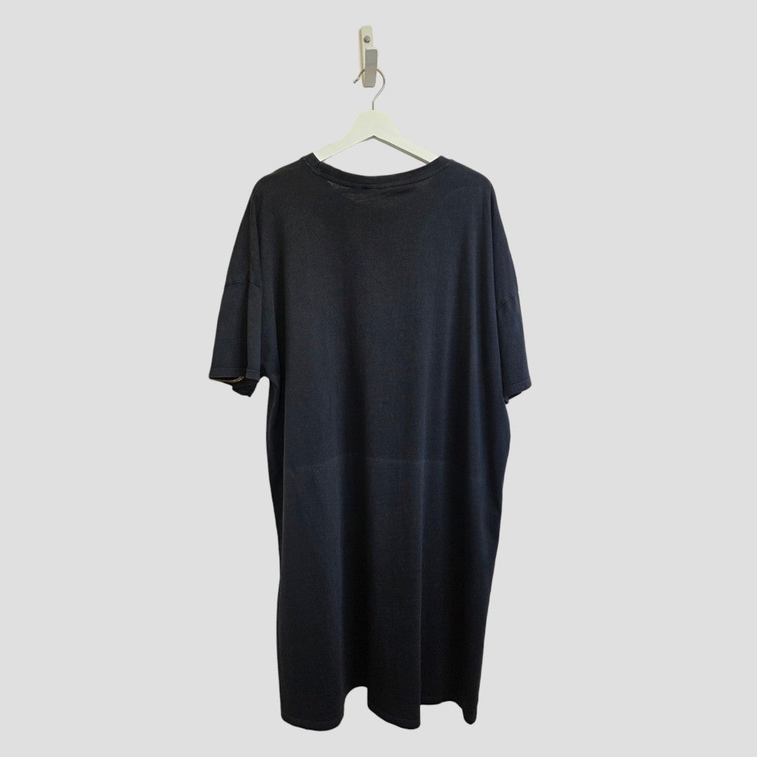 A plain black "Upcycled Breastfeeding (Nursing) & Pumping The Doors Oversized Band t-shirt dress" by Primark in size L (UK14/16) hangs on a white hanger against a light gray background. Designed for comfortable breastfeeding, the dress is displayed from the back.