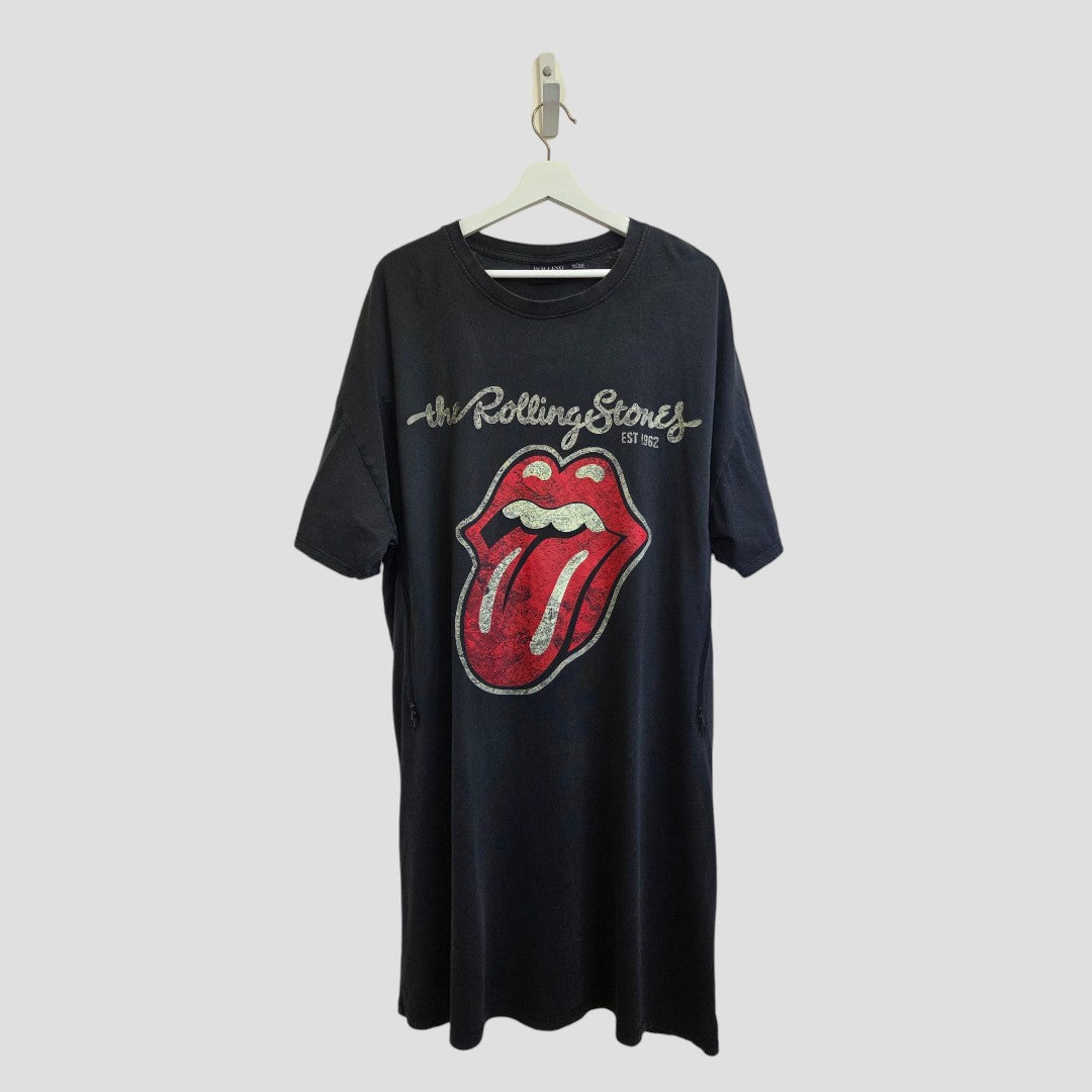 The Upcycled Breastfeeding (Nursing) & Pumping The Rolling Stones Oversized Band t-shirt dress L (UK14/16) by Primark features a black t-shirt dress hanging on a hanger, adorned with The Rolling Stones logo—red tongue and lips—and "The Rolling Stones Est 1962" in silver text above. This affordable piece doubles as stylish, casual breastfeeding clothing.