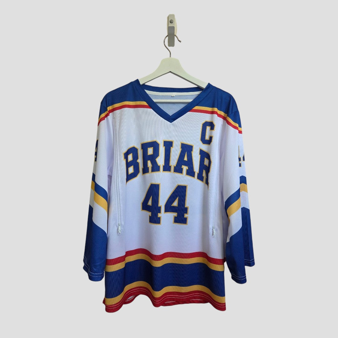 An upcycled breastfeeding and pumping white Off Campus ice hockey jersey t-shirt by Amazon, featuring blue, red, and yellow accents, the word "BRIAR," the number 44, and a captain’s C on the chest, hangs on a hanger against a plain background—offering fans an eco-friendly alternative to traditional nursing clothing.
