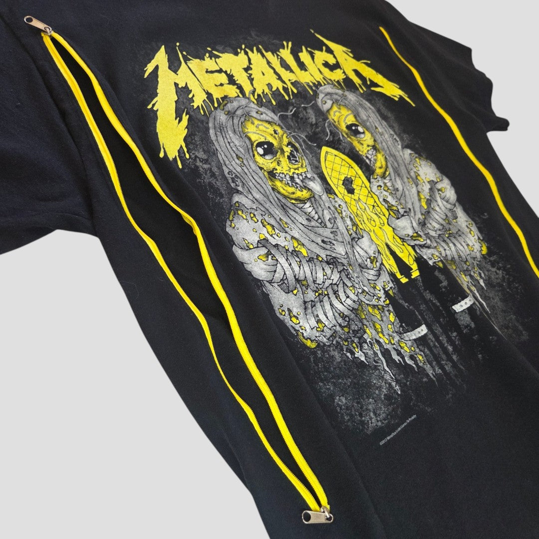 Introducing the Upcycled Breastfeeding (Nursing) & Pumping Black/Yellow Metallica Band t-shirt L (100604) by Gildan: a black t-shirt adorned with a yellow and gray graphic of two zombie-like figures beneath the bold, jagged yellow Metallica logo, featuring two yellow zippers running diagonally across the front. Perfect for new moms seeking an edgy design with stylish, affordable functionality for nursing or pumping.