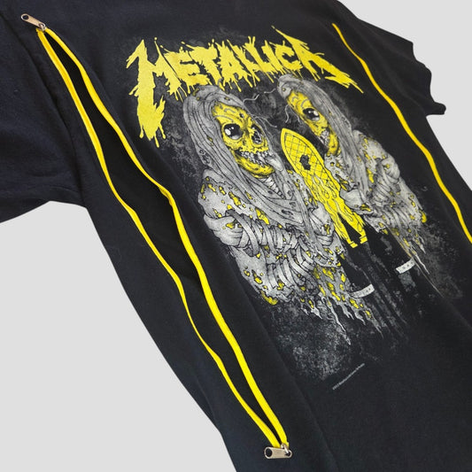 Introducing the Upcycled Breastfeeding (Nursing) & Pumping Black/Yellow Metallica Band t-shirt L (100604) by Gildan: a black t-shirt adorned with a yellow and gray graphic of two zombie-like figures beneath the bold, jagged yellow Metallica logo, featuring two yellow zippers running diagonally across the front. Perfect for new moms seeking an edgy design with stylish, affordable functionality for nursing or pumping.