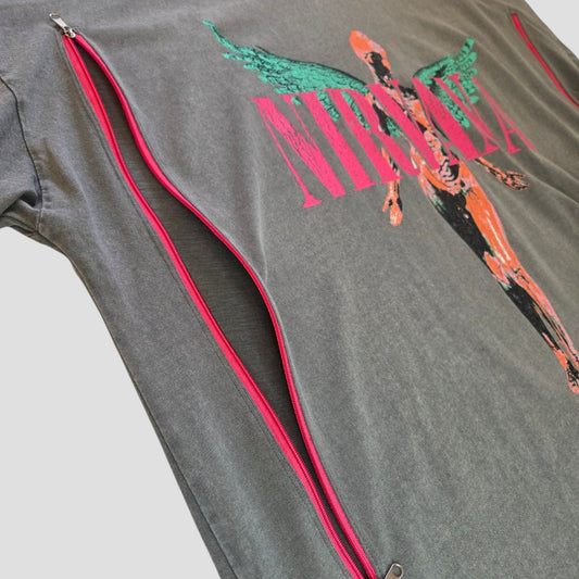An upcycled Primark Nirvana band t-shirt dress in grey and pink (size L, UK14/16) features a colorful graphic with two red zippers running diagonally down the left side—partially unzipped to reveal inner layers—making it an affordable and stylish breastfeeding or pumping option that provides easy access and nursing-friendly convenience.