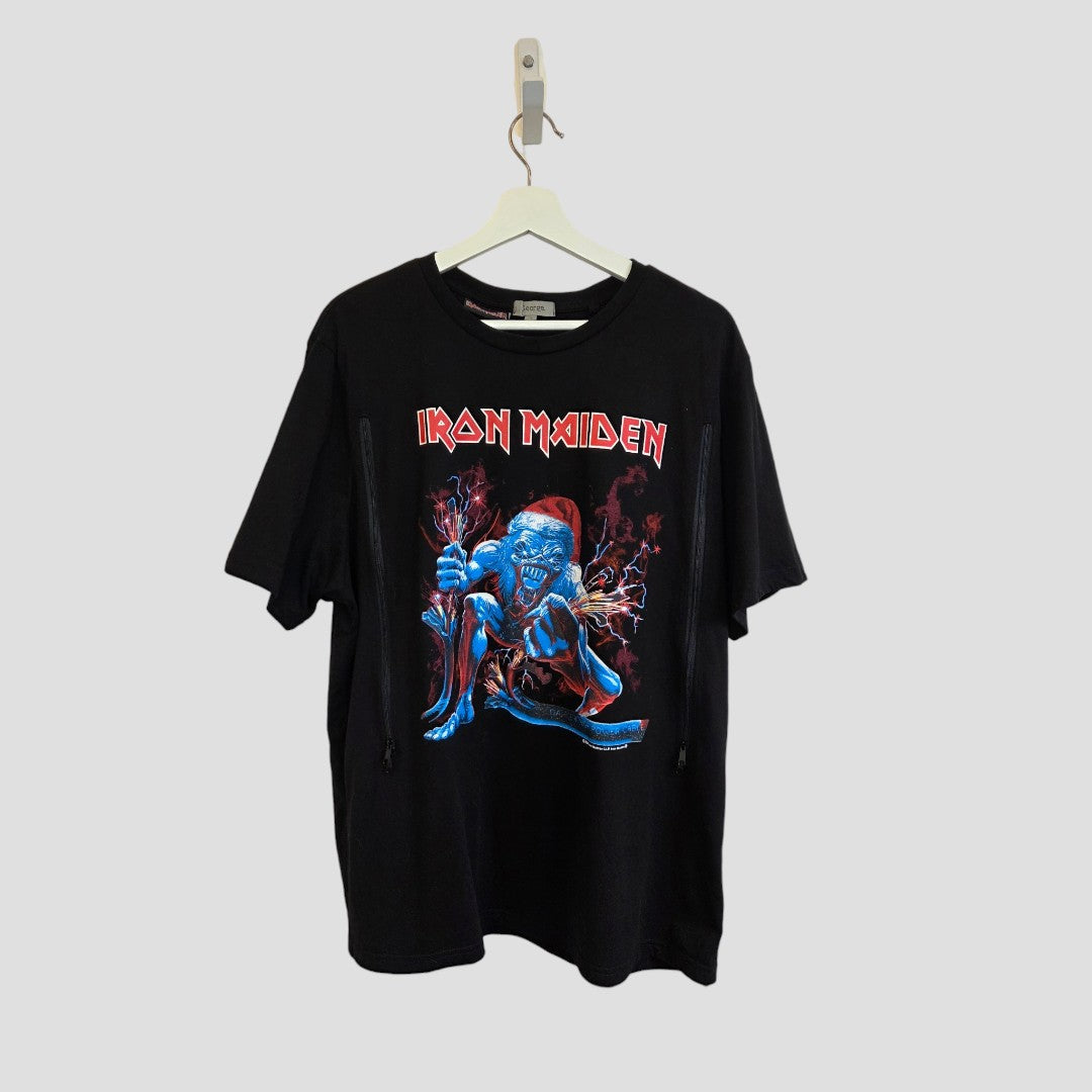 An upcycled Iron Maiden Christmas nursing and pumping T-shirt by George in black—featuring a blue zombie-like character graphic with red lightning—hangs on a white hanger against a plain gray background.