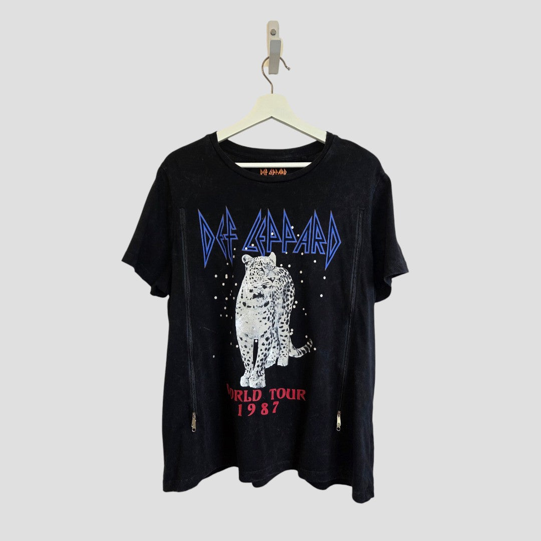 Upcycled Black Def Leppard Snow Band t-shirt (size L) from the brand Def Leppard, designed for breastfeeding and pumping, displayed on a hanger against a plain gray background.