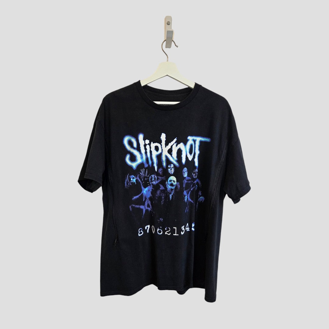 Upcycled Black/Blue Slipknot Band Nursing & Pumping T-shirt (M) by Slipknot, displayed on a hanger, featuring the band’s name in bold blue text, masked band member portraits, and white 870621345 numbers beneath the graphic—a distinctive and affordable choice of nursing wear for those who want to express their unique style.
