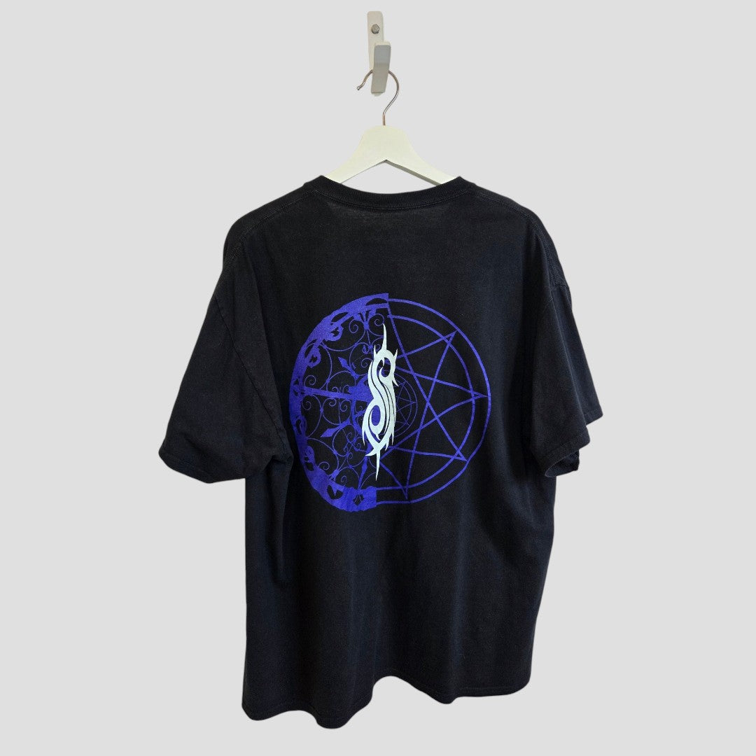 A Slipknot Upcycled Breastfeeding (Nursing) & Pumping Black/Blue Band T-shirt in medium is displayed on a white hanger, showcasing a blue circular design with intricate patterns and a stylized S logo centered on the back. Made from sustainable, upcycled materials for eco-conscious nursing wear, this stylish piece stands out against a plain light gray background.