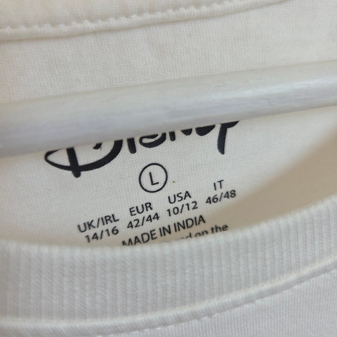 Close-up of the collar tag on a white Primark shirt featuring the Disney logo, size L (UK 14/16), along with size conversions: EUR 42/44, USA 10/12, IT 46/48. The tag also states MADE IN INDIA. This Upcycled Breastfeeding & Pumping Cream Winnie the Pooh & Friends t-shirt (100601) is an ideal addition to any collection of affordable nursing tops or breastfeeding clothing options.