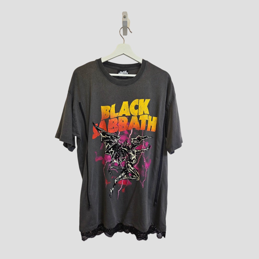 A grey and orange lace-trimmed, upcycled Black Sabbath oversized band t-shirt for breastfeeding and pumping, by Primark, designed as affordable maternity wear, is hanging on a white hanger against a plain light background.