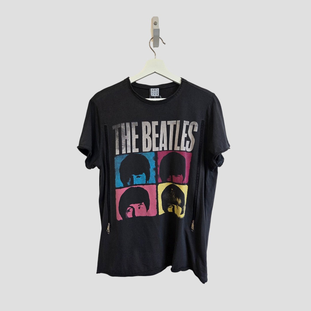 Amplified Upcycled Breastfeeding (Nursing) & Pumping The Beatles Colourblock Band t-shirt (M, 100592) features a black design on a hanger with “The Beatles” text and four colorful squares—each displaying a stylized portrait of a band member’s face in blue, pink, red, and yellow. This eco-friendly t-shirt is an ideal sustainable choice for music-loving parents.