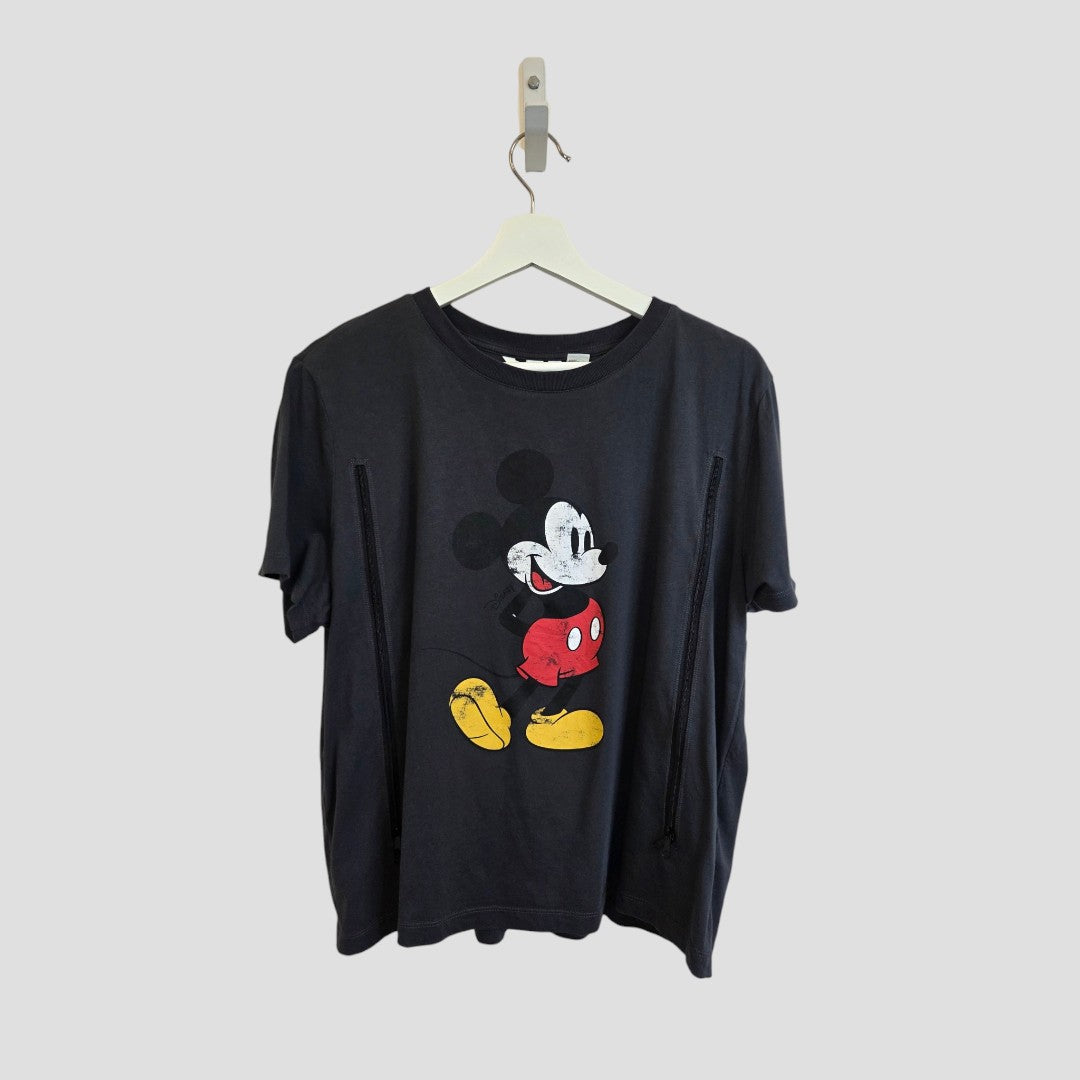 Grey Upcycled Breastfeeding (Nursing) & Pumping Mickey Mouse t-shirt by H&M (size L)—a budget-friendly option designed for stylish comfort, featuring a classic Mickey Mouse graphic, ideal for fans and nursing moms alike. Seen hanging on a white hanger against a plain light gray background.