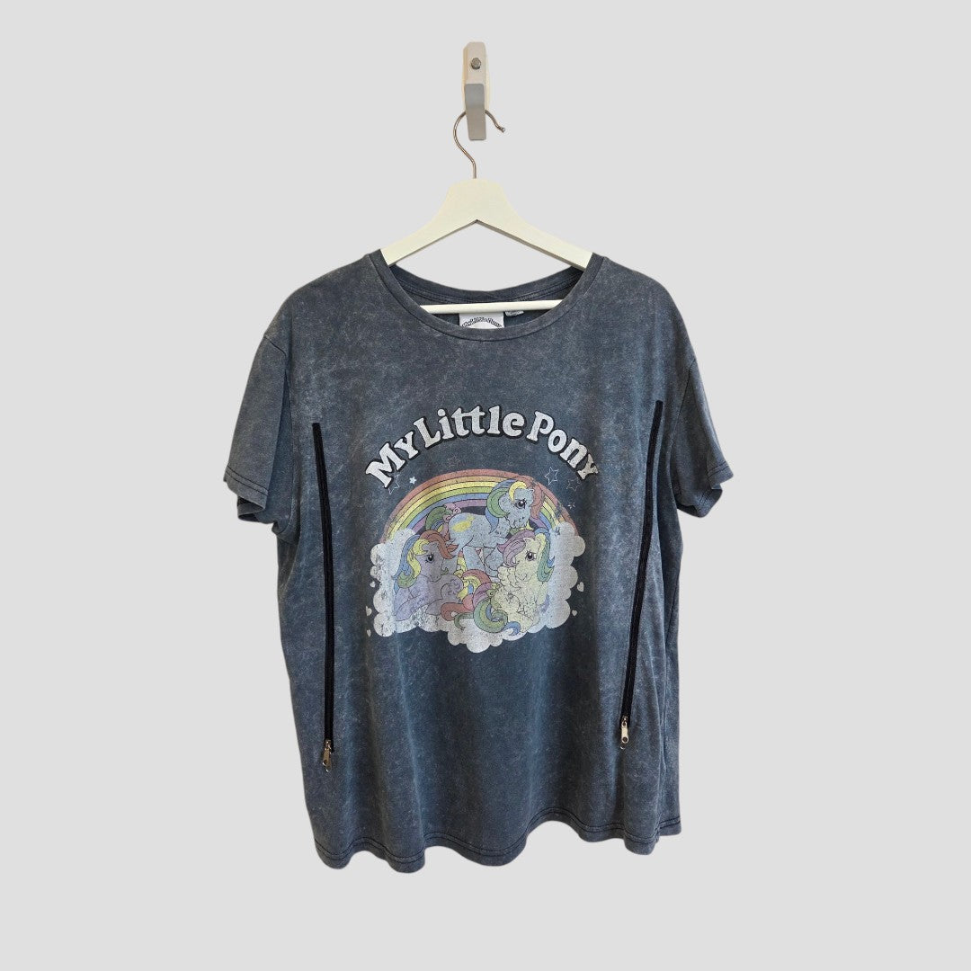 An upcycled Primark Upcycled Breastfeeding (Nursing) & Pumping Grey My Little Pony t-shirt in UK14 hangs on a hanger. This dark gray tee showcases a vibrant rainbow and colorful pony graphic with “My Little Pony” text above, making it a comfortable, fun, and budget-friendly choice for fans seeking affordable nursing or casual breastfeeding clothing.