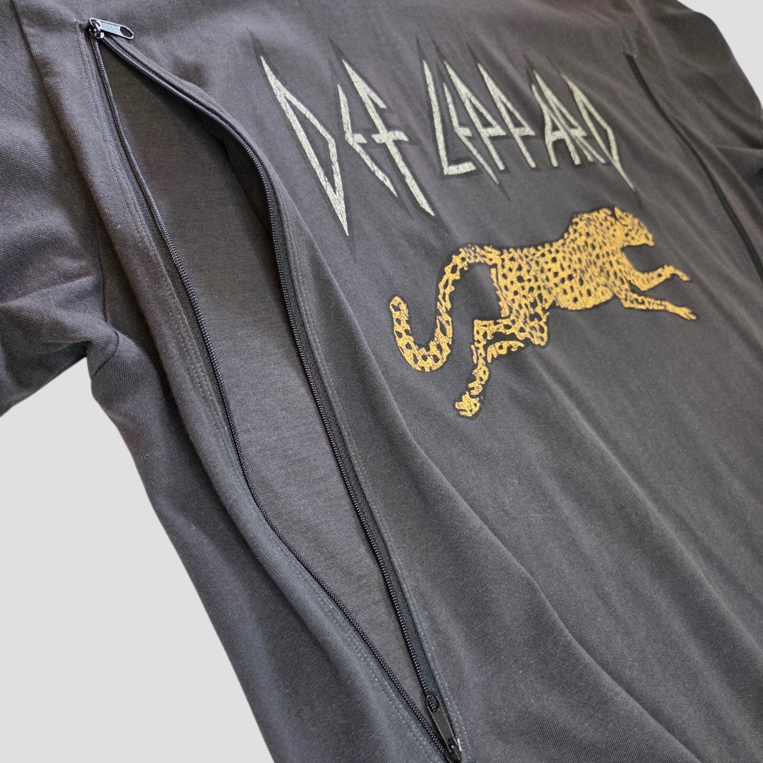 Upcycled from a Def Leppard band t-shirt in grey, this H&M XL nursing top features a yellow cheetah graphic and a diagonal zipper from collar to side seam for easy breastfeeding access, shown against a gray background.