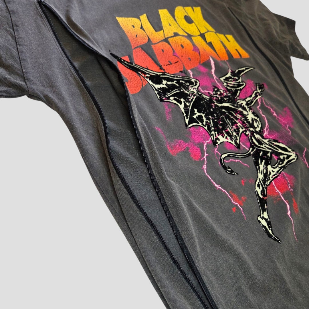 Here’s the rewritten sentence using your product data: A Primark “Upcycled Breastfeeding (Nursing) & Pumping Grey/Orange Lace Black Sabbath Oversized Band T-shirt” (size S, 100586), featuring yellow and red text along with a bat-like figure accented by black, white, and pink lightning, is unzipped and laid flat on a light background—ideal for those seeking affordable maternity wear or stylish nursing clothing.