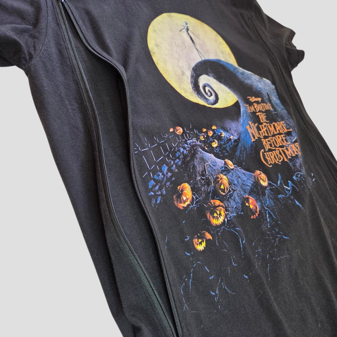 Introducing the Upcycled Breastfeeding (Nursing) & Pumping The Nightmare Before Christmas T-shirt L (100595) by Truffle Shuffle—a black tee showcasing iconic artwork from the classic film, including a moon, hill, Jack Skellington, pumpkins, and the movie title in striking orange and yellow text. Designed for stylish and affordable nursing wear, this upcycled piece offers convenient access for breastfeeding or pumping while letting you celebrate your love for The Nightmare Before Christmas.