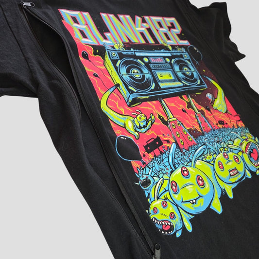An upcycled Gildan black Blink-182 Stereo Band T-shirt (size L) featuring a vibrant cartoon graphic of a large boombox, green monsters, and a red cityscape—designed as affordable nursing and pumping wear for those who love bold, standout styles.