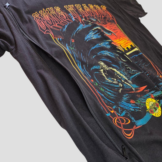 Upcycled Breastfeeding (Nursing) & Pumping Black Guns n Roses Surf Band t-shirt by Guns n Roses in size L, featuring a vibrant and artistic design with swirling blue accents, a skeleton, and a red-yellow sunset. This affordable nursing clothing option offers edgy style along with practical side zipper access for convenient breastfeeding or pumping.