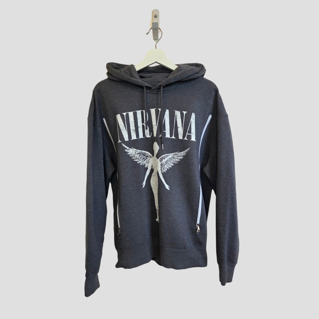 An upcycled grey and white Nirvana Angel Band hoodie for breastfeeding and pumping (size M) from Primark, displaying the band’s name and angel graphic on the front, is shown hanging on a white hanger against a plain light background.
