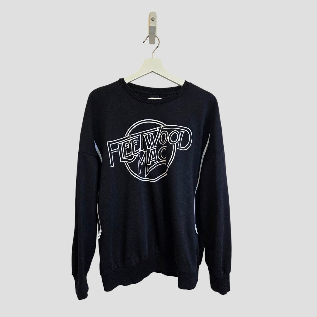 An upcycled black and white Fleetwood Mac band sweatshirt by George, designed for breastfeeding and pumping, in size medium (100576), is displayed on a white hanger against a plain gray background.
