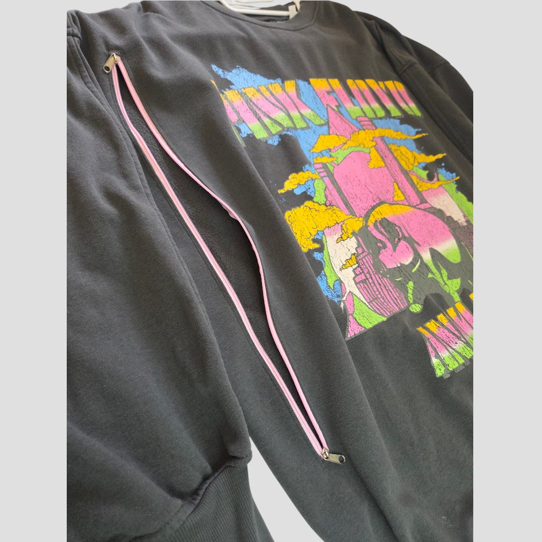 An upcycled H&M Pink Floyd band sweatshirt dress in grey, featuring colorful chest graphics and a pink diagonal zipper across the front—partially unzipped to reveal the inner lining—seamlessly blending modern style with practical breastfeeding and pumping functionality.