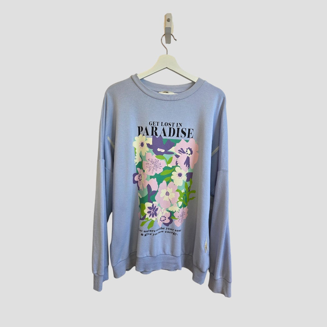An upcycled George breastfeeding and pumping lightweight sweatshirt in blue floral paradise print, size XL (UK 20/22), featuring the text “GET LOST IN PARADISE” on the front, is displayed on a white hanger against a plain background.