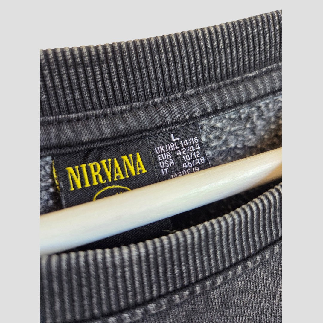 Close-up of a Primark Upcycled Breastfeeding (Nursing) & Pumping Grey/Orange Nirvana Angel Band Sweatshirt in size L (UK14/16), highlighting the regional size tags and displayed on a wooden hanger—an affordable addition to your breastfeeding wardrobe.
