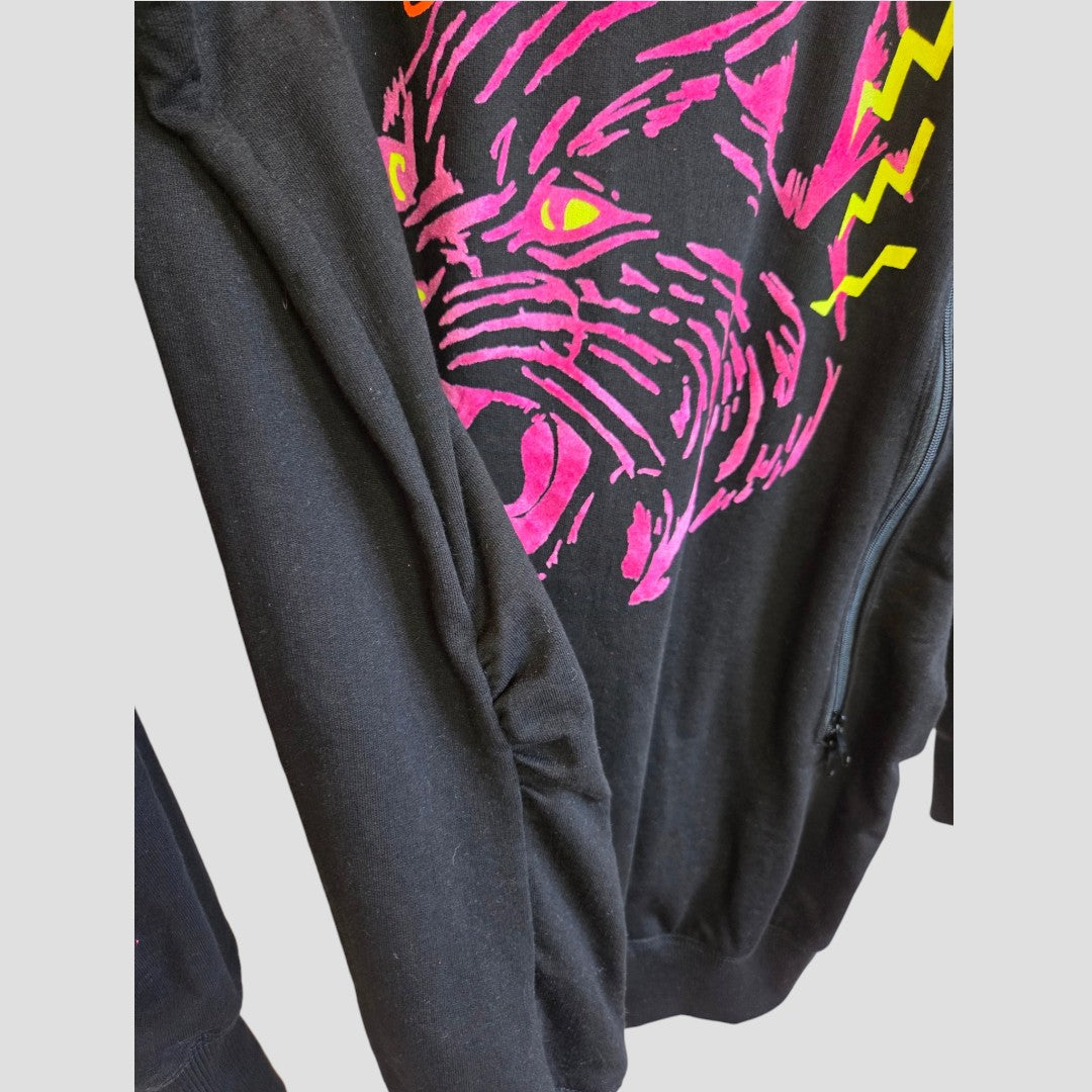 The Nine+ Quarter Upcycled Breastfeeding (Nursing) & Pumping Black Tiger Maternity Sweatshirt (M, 100648) showcases a striking pink and yellow tiger graphic with bold eyes and dynamic accents, making it a standout piece that effortlessly enhances your wardrobe of organic cotton maternity sweatshirts and stylish nursing clothes.
