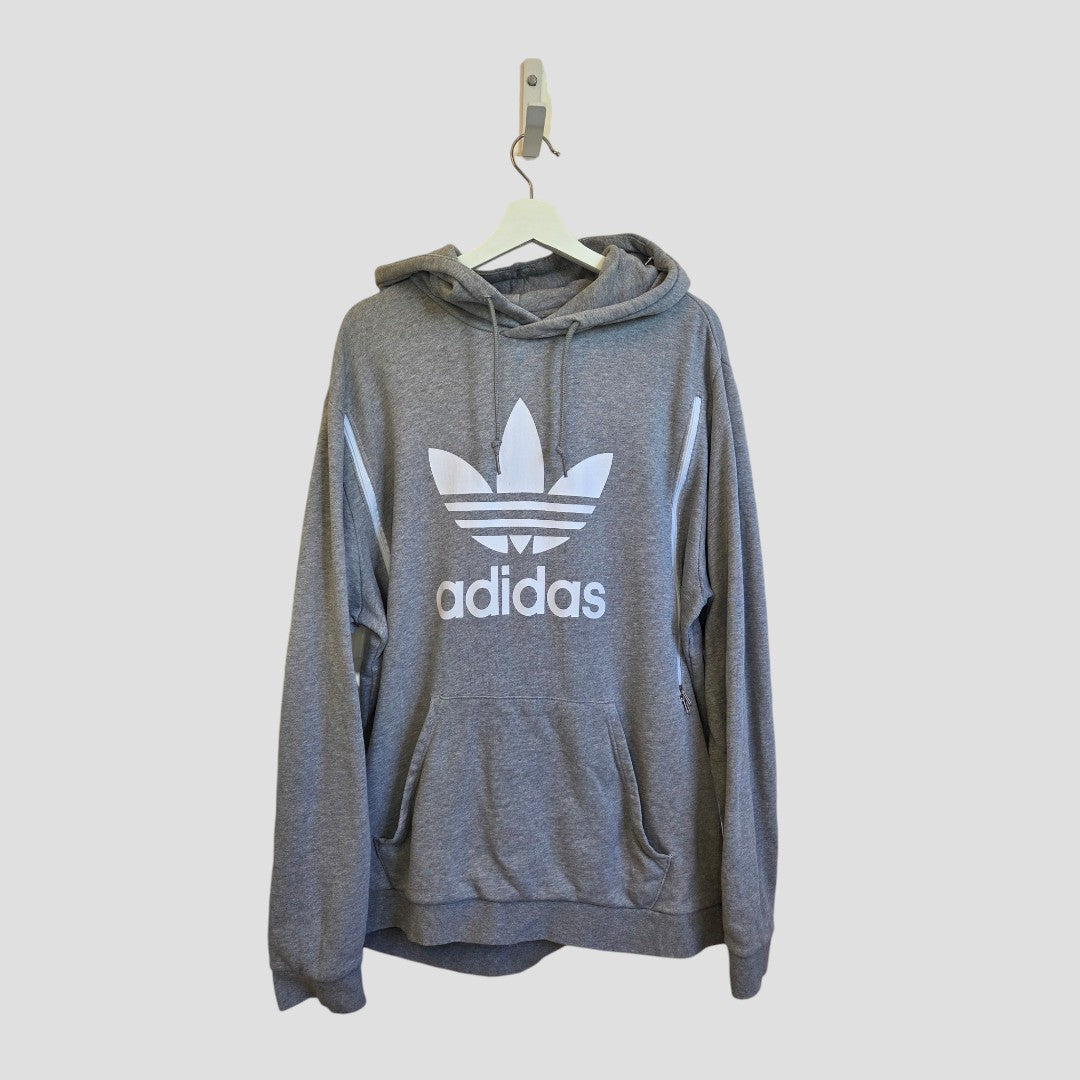 An upcycled Adidas Breastfeeding (Nursing) & Pumping Grey/White Hoodie in XL, featuring a bold white trefoil logo and adidas text on the front, hangs on a white hanger against a light gray background—an affordable and stylish option designed for comfortable nursing.