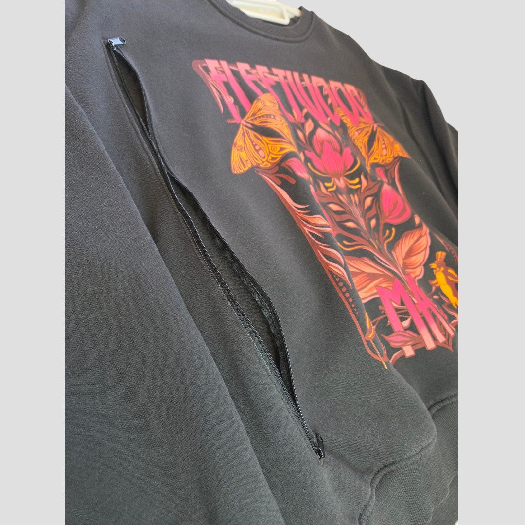 Primark’s Upcycled Breastfeeding (Nursing) & Pumping Floral Fleetwood Mac Band Sweatshirt in size M (UK12/14) (100441) features a black base adorned with vibrant pink and orange floral and butterfly graphics, along with the text “RESTITCHED MAN.” Designed as an eco-conscious alternative, this nursing sweatshirt includes a large zippered pocket on the chest for convenient breastfeeding or pumping access, seamlessly blending style and practicality. The product is photographed against a plain light gray