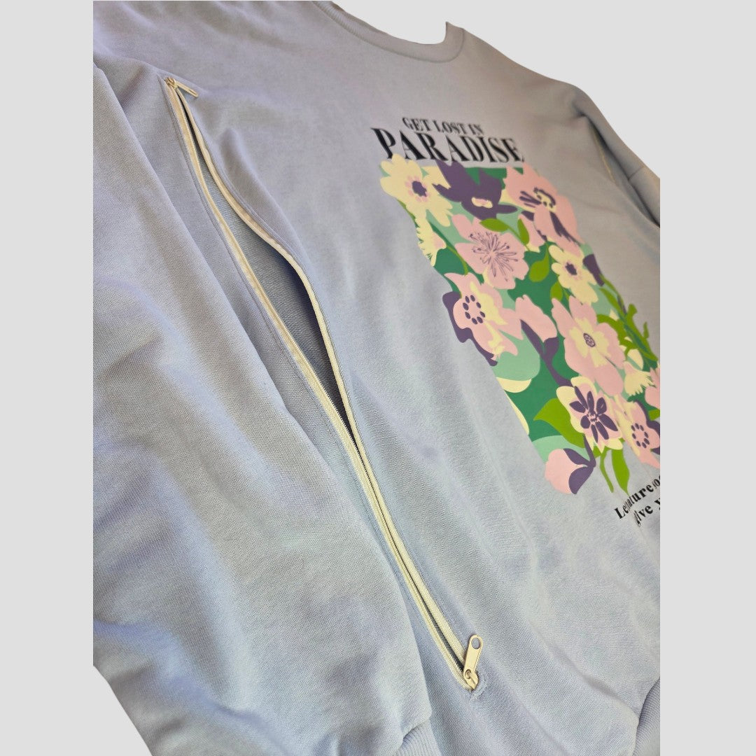 Introducing the Upcycled Breastfeeding (Nursing) & Pumping Blue Floral Paradise Lightweight Sweatshirt from George. This light blue sweatshirt features a floral graphic and the phrase “Get Lost in Paradise.” Thoughtfully designed as affordable nursing wear, it offers a discreet white zipper along the side seam—partially unzipped for convenient breastfeeding or pumping access, while maintaining effortless style and comfort. Available in size XL (UK 20/22).
