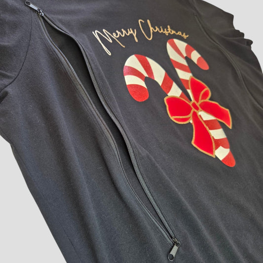 The F&F Upcycled Breastfeeding (Nursing) & Pumping Black Christmas Candy Canes t-shirt UK22 (100657) features two diagonal zippers for convenient nursing access and is adorned with a “Merry Christmas” message above two red-and-white candy canes tied with a red bow, offering affordable festive style and practicality for breastfeeding mothers.