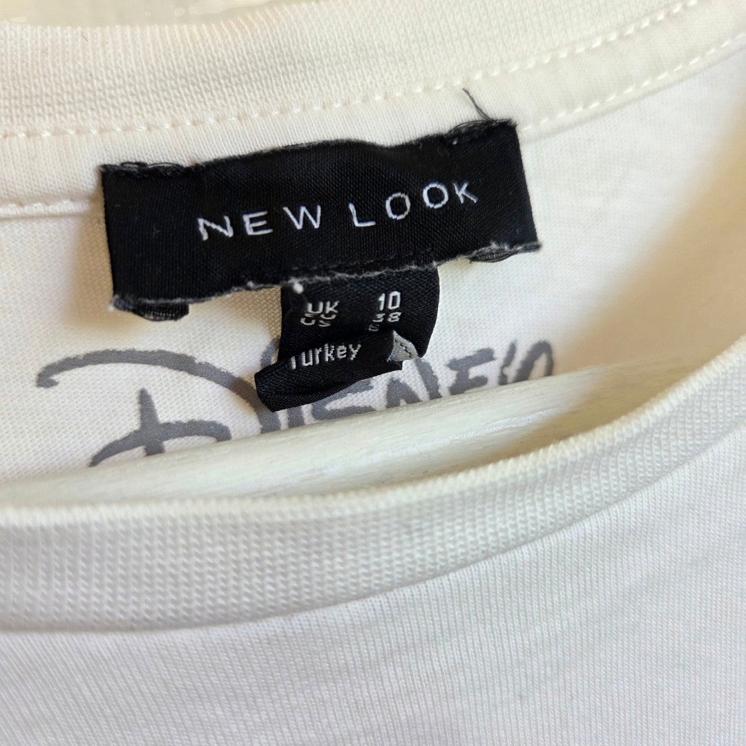 The inner neckline of a white, eco-friendly New Look Upcycled Breastfeeding (Nursing) & Pumping Cream Mickey Mouse Flowers t-shirt UK10 (100638), showing a brand tag above a size 10 label and a faint Disney logo printed on the fabric.