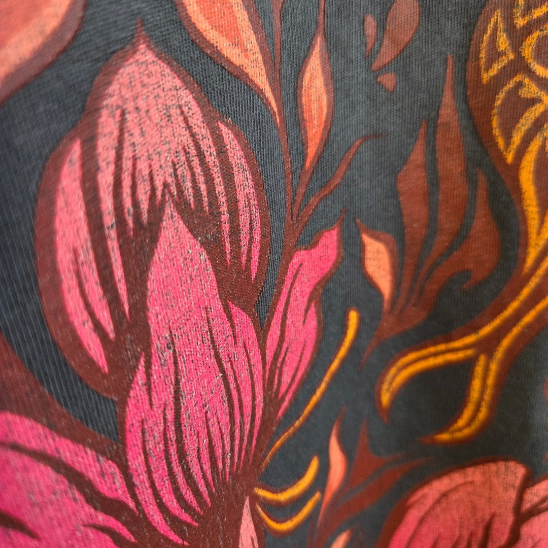 Close-up of the Upcycled Breastfeeding (Nursing) & Pumping Grey Floral Fleetwood Mac Band t-shirt L (UK14/16) (100624) fabric, featuring grey eco-friendly material printed with large pink and orange stylized floral and leaf patterns.